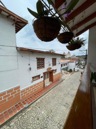 a house with plants hanging from a building at Casa Hotel Spa Carolina in Carolina del Principe
