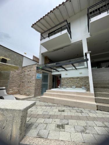 a building with a staircase leading to a building at Casa Hotel Spa Carolina in Carolina del Principe