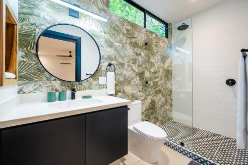 a bathroom with a sink and a mirror at 2 Nature Villas with Pool in Santa Cruz