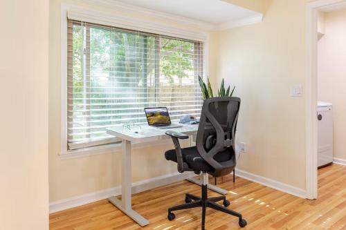 an office with a desk and a chair in front of a window at Cozy Retreat Close to Downtown in Charleston