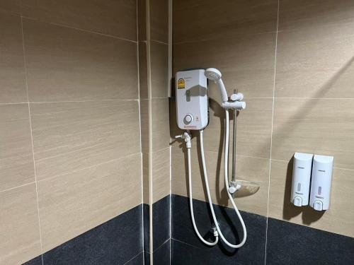 a shower in a bathroom with a hanger at V Tharm Hotel in Udon Thani