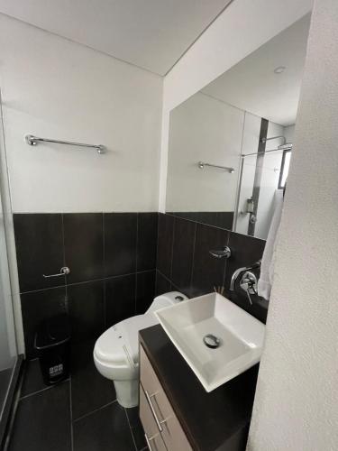 a bathroom with a white toilet and a sink at Casa Hotel Spa Carolina in Carolina del Principe