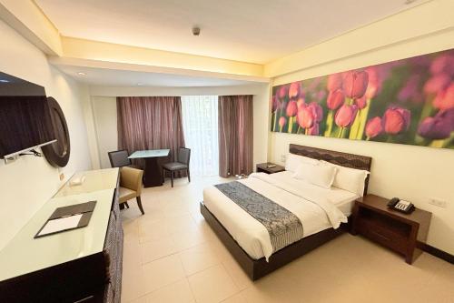 a hotel room with a bed and a desk at The Muse Hotel Boracay in Boracay