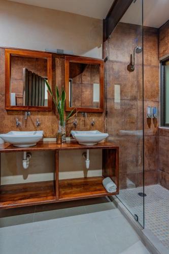 a bathroom with two sinks and a shower at Casa Tolok in Mérida