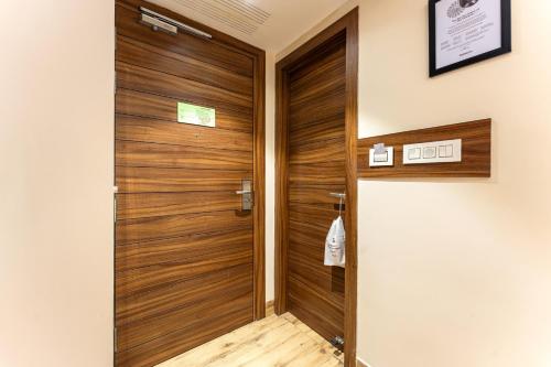 a wooden door in a room with a wooden floor at Medalio Boutique Chandigarh Zirakpur in Zirakpur