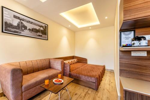 a living room with a couch and a table at Medalio Boutique Chandigarh Zirakpur in Zirakpur