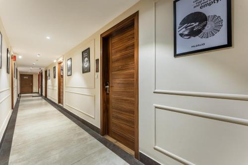 a hallway with a wooden door in a building at Medalio Boutique Chandigarh Zirakpur in Zirakpur