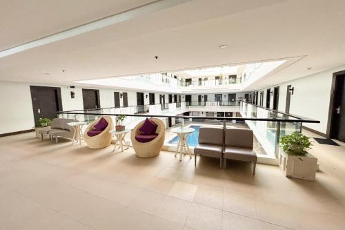 a large room with chairs and a bar in a building at The Muse Hotel Boracay in Boracay