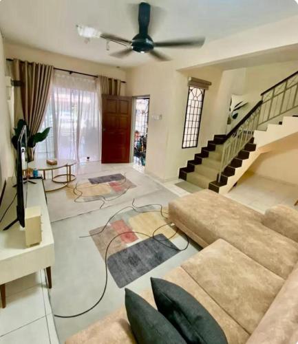 a living room with a couch and a ceiling fan at Inap Semarak Batang Kali in Batang Kali