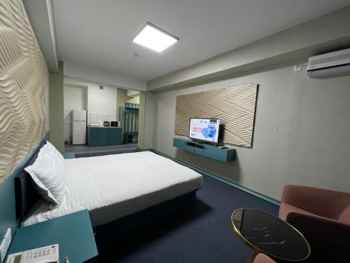 a hospital room with a bed and a tv at Telmuun tower hotel in Ulaanbaatar