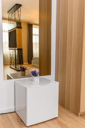 a room with a white table and a mirror at B-Holiday Luxury GuestHouse in Prejmer