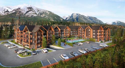 an aerial view of a resort with cars parked in a parking lot at Brand New Mountain Retreat! in Canmore