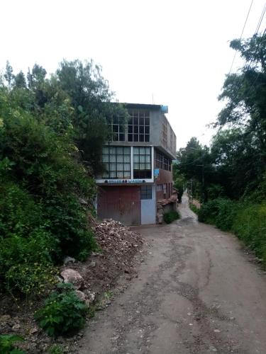 a building on the side of a dirt road at Hostal Aylluq Wasin - Guest House-Casa de Familia in Urubamba