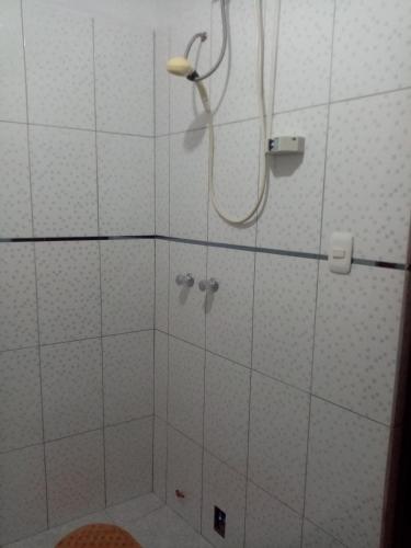 a bathroom with a shower with a shower head at Hostal Aylluq Wasin - Guest House-Casa de Familia in Urubamba