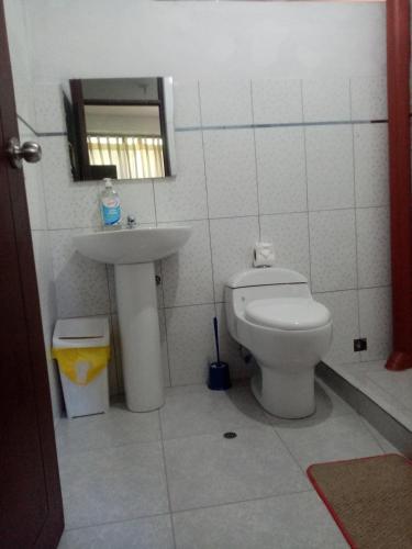 a bathroom with a toilet and a sink at Hostal Aylluq Wasin - Guest House-Casa de Familia in Urubamba