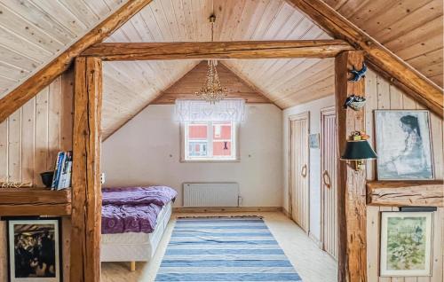 a bedroom with a bed in a room with wooden ceilings at Awesome Home In Skövde With Sauna in Skövde