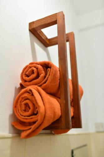 a pile of towels on a towel rack in a bathroom at Ranketha Hideout Resorts in Kurunegala