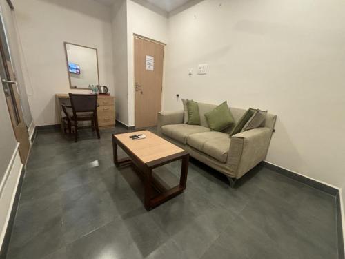 a living room with a couch and a coffee table at Vizag Comforts in Visakhapatnam