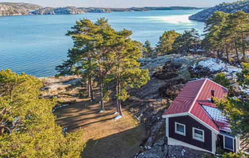 an aerial view of a red house on the shore of a lake at Beautiful Home In Lysekil in Lysekil