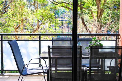 a table and chairs sitting on a balcony at Comfy 2-bedroom 2-balcony apartment Close to CBD, Train and Metro easy reach in Sydney