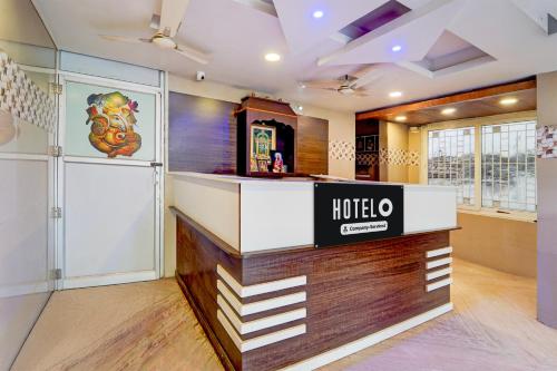a hotel lobby with a reception counter in a room at Super Hotel O Anna Nagar Madurai in Madurai