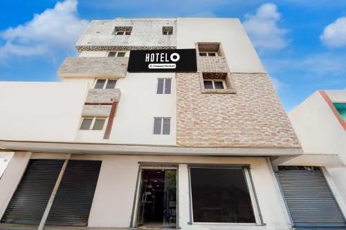 a building with a hotel sign on it at Super Hotel O Anna Nagar Madurai in Madurai