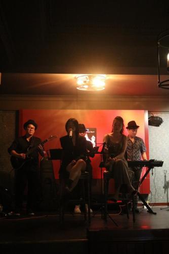 a group of people sitting on a stage with instruments at La Bonita - Phu My Hung in Ho Chi Minh City