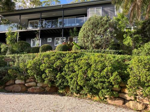 a house with bushes in front of it at Surf'n'Joe luxury one bedroom suite in Palm Beach