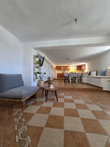 a living room with a couch and a table at Tamarisk House-An Ideal Getaway in Southern Paros in Márpissa