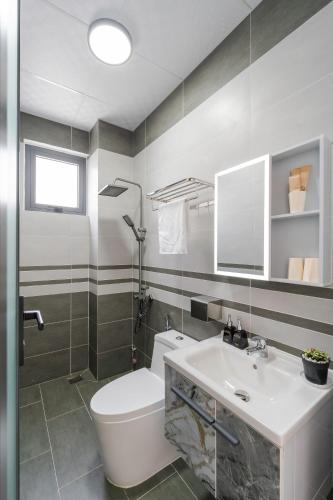 a bathroom with a white toilet and a sink at Hoàng Hiệp Villa in Da Lat
