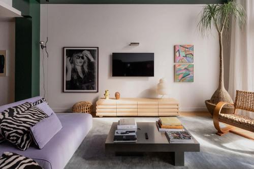 a living room with a couch and a table at A luxe stay in the Paris end of Melbourne in Melbourne