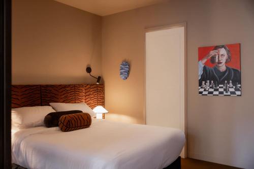 a bedroom with a bed and a painting on the wall at A luxe stay in the Paris end of Melbourne in Melbourne