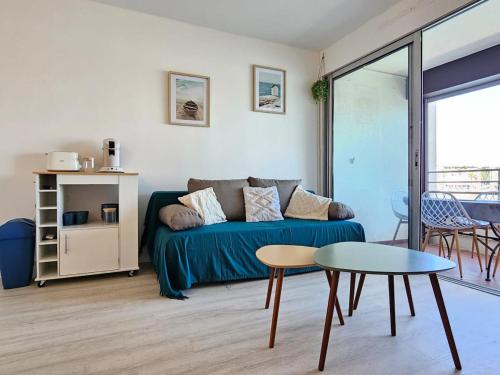 un salon avec un canapé et une table dans l'établissement T2 climatisé magnifique vue port, à Gruissan