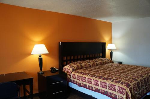 a hotel room with a bed and two lamps at Sherman Inn in Sherman