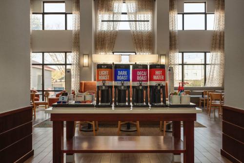 a table with a bunch of soda bottles on it at Hampton Inn & Suites San Marcos in San Marcos