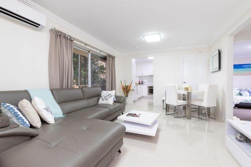 a living room with a couch and a table at Anchorage 31 in Tuncurry