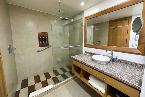 a bathroom with a sink and a shower at Wyndham Garden Quito in Quito
