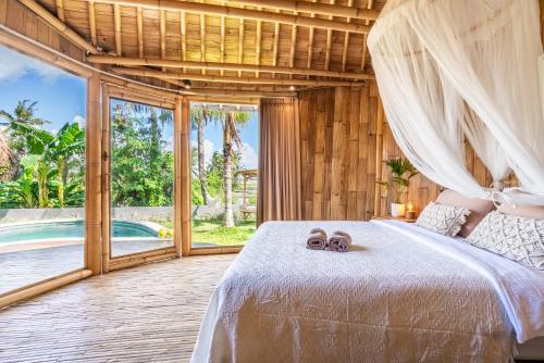 Ένα ή περισσότερα κρεβάτια σε δωμάτιο στο Noon Bamboo Villas