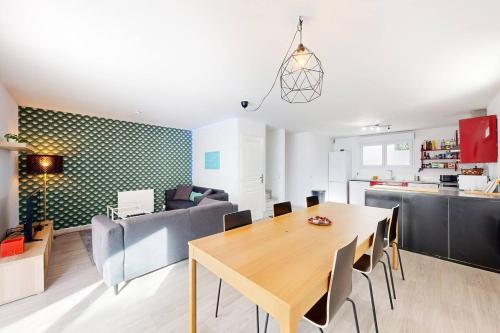 une salle à manger et une cuisine avec une table et des chaises dans l'établissement Laharie - CI - PB - Triplex 118m2 avec grande terrasse et parking, à Bayonne
