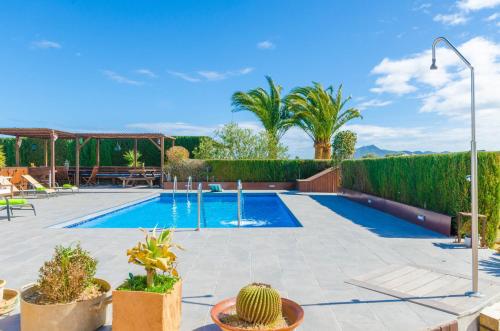 a swimming pool in a yard with cacti at Es Rafal Nostro in Felanitx