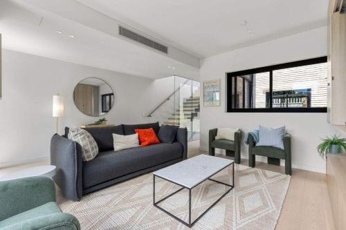 a living room with a couch and two chairs at Beautiful Holiday Home w Private Terrace in Sydney
