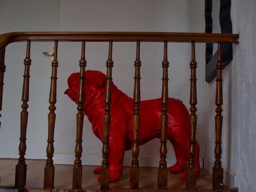 a red stuffed animal is sitting on a railing at Apparement plein centre ville in Béthune