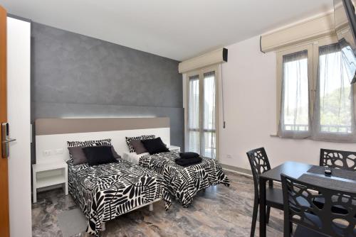 a bedroom with a bed and a table and chairs at Affittacamere Jesi in Iesi