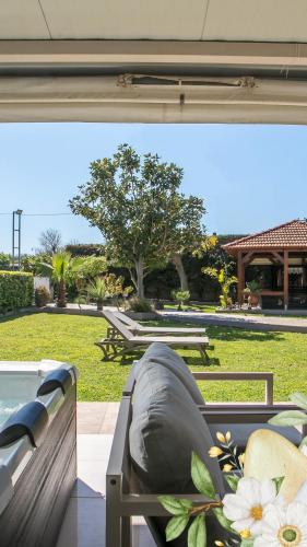 a view of a patio with a hot tub and a park at Sea Breeze & Nature villa ,near the sea, luxury jagguzi and spa private garden in Kremasti