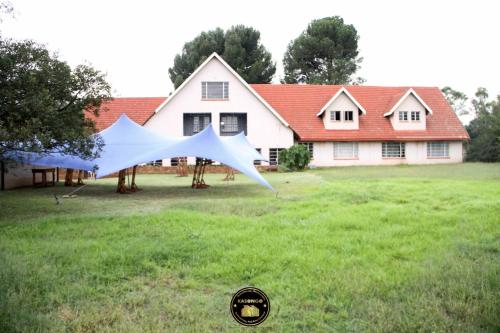 a kite is flying in front of a house at KSG GuestFarm in Eikenhof