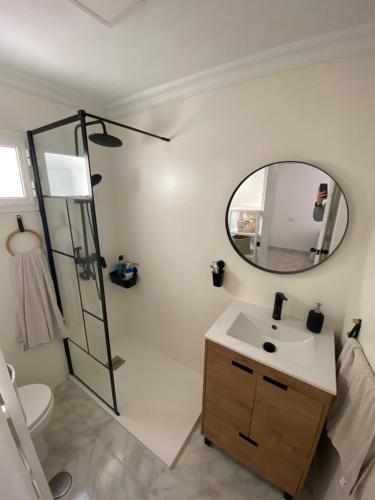 a bathroom with a sink and a mirror at Casa El Rincón de San Pedro in Arcos de la Frontera