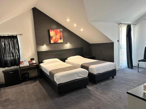 a hotel room with two beds and a staircase at Sienna Apartments in Skopje