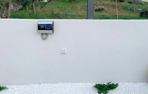 a wall with a blue mailbox on the side of it at Villa Noeli in Hum