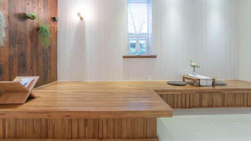 a wooden counter in a room with a window at Hello jeje Guesthouse in Jeonju