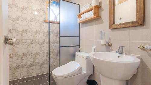 a bathroom with a toilet and a sink and a shower at Hello jeje Guesthouse in Jeonju